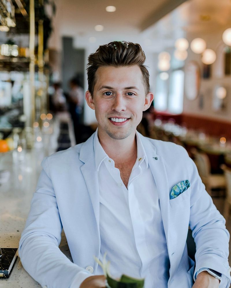 Smiling business professional in a light blazer ready to meet a new client