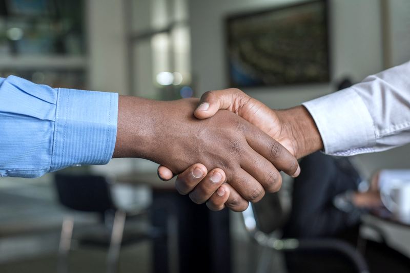 Two business professionals shaking hands to seal a new partnership