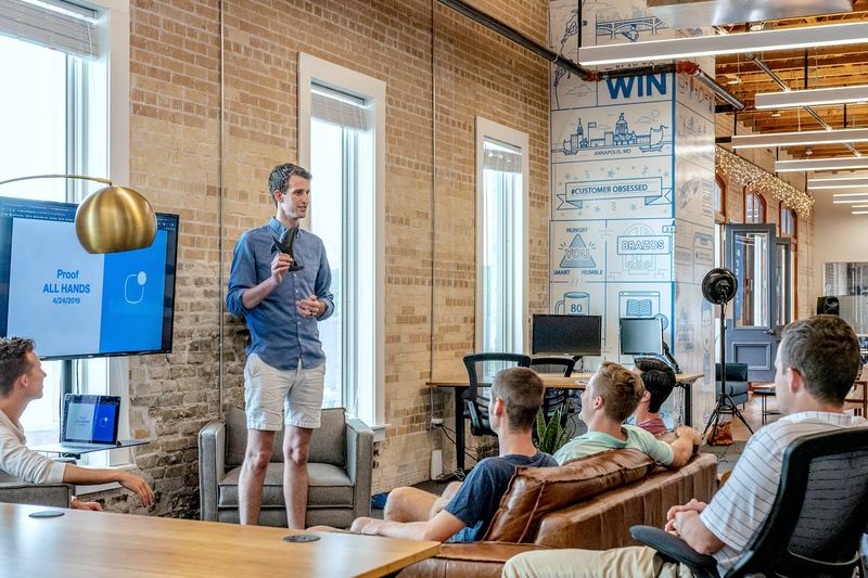 Team leader coaching a group of new team members in a bright open office